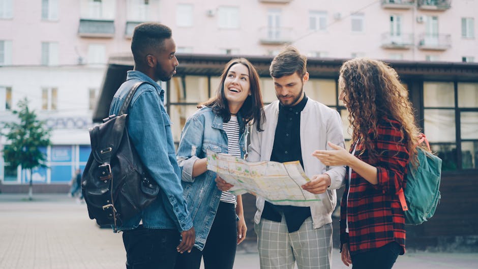 Four young friends reading a map outdoors, planning their city adventure