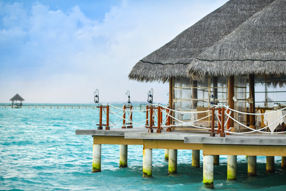 Scenic view of a tropical overwater bungalow on a crystal-clear sea, perfect for a luxurious vacation