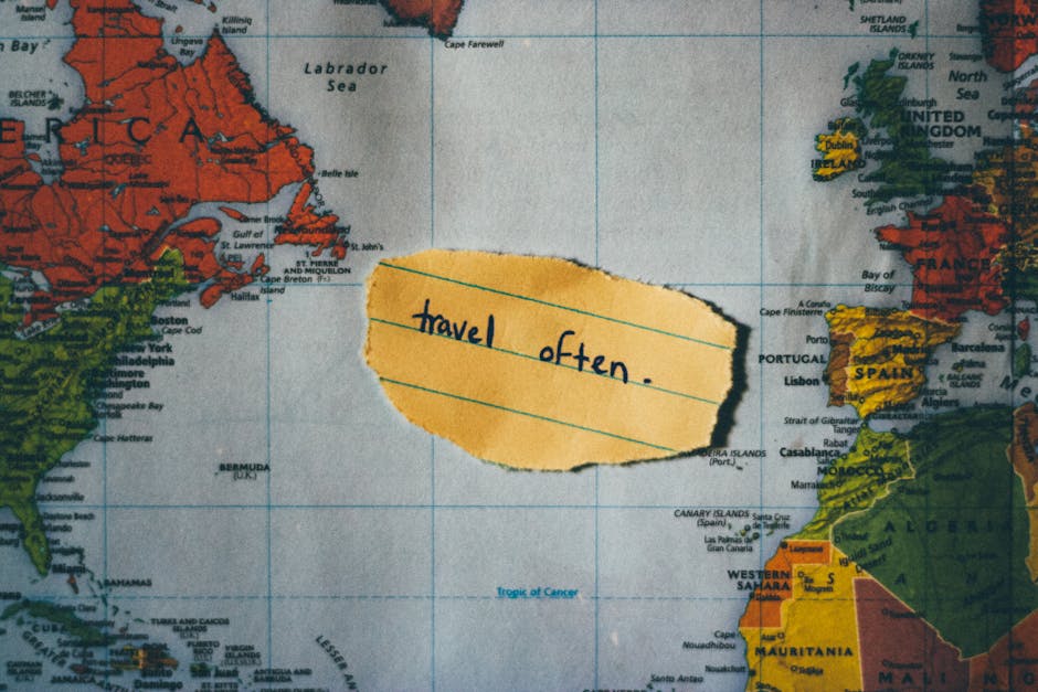 A motivating note 'travel often' placed over a colorful world map, inspiring exploration