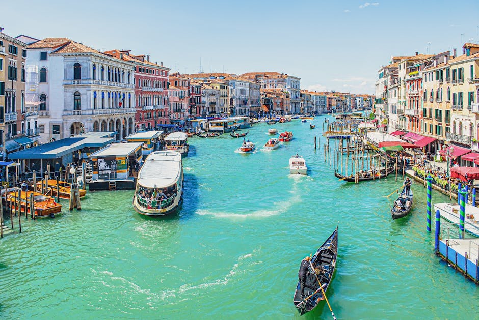 Lively view of boats and gondolas on Venice's Grand Canal, showcasing its historic architecture
